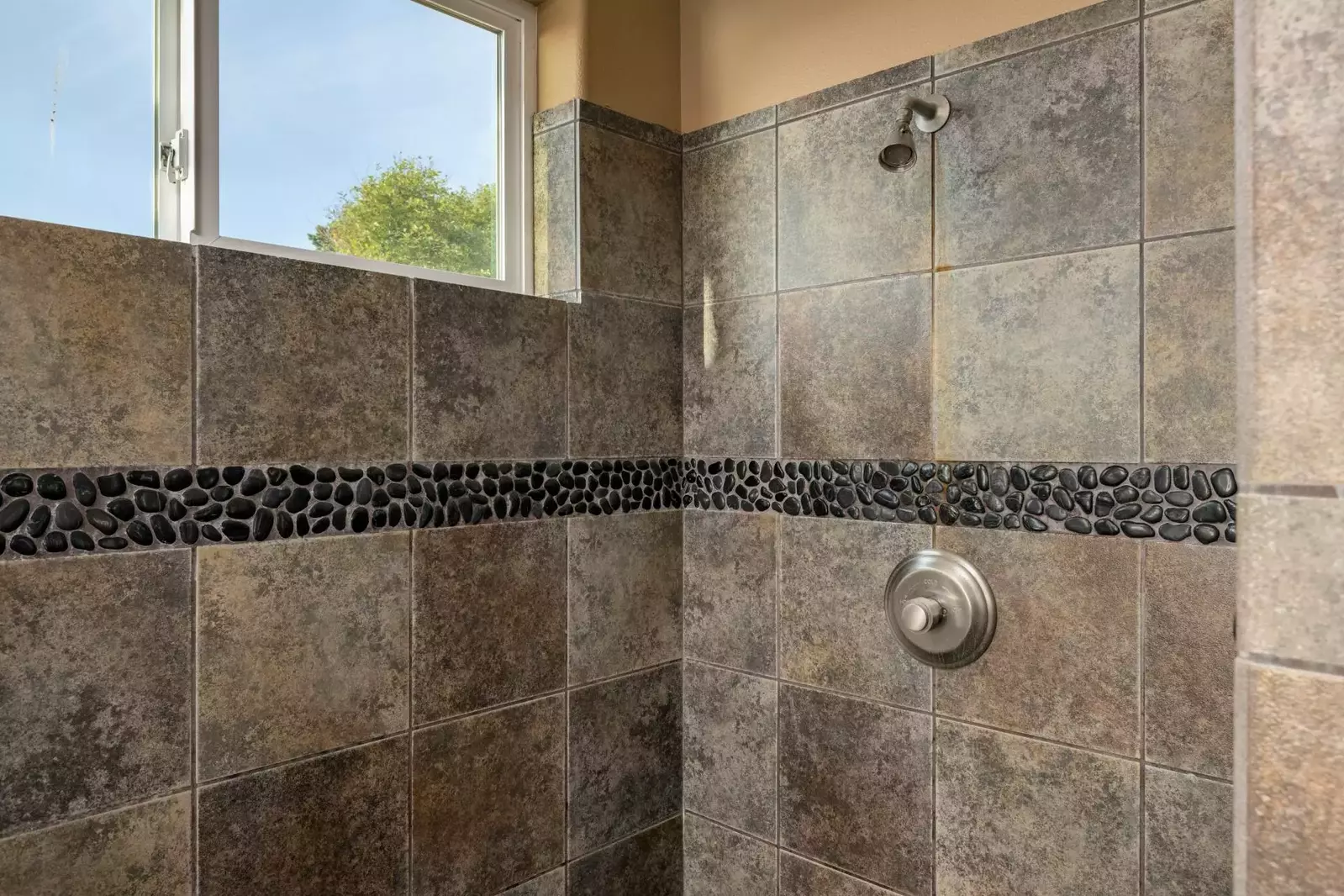 The shower is spacious, up to date, and has excellent water pressure.