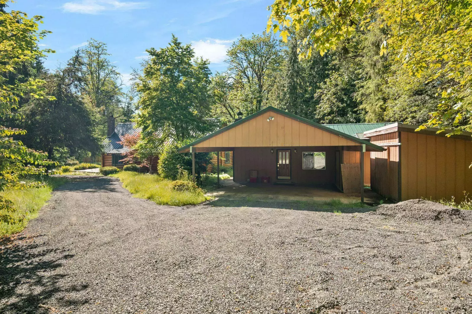 The Fernwood guest cabin and main house at arrival.