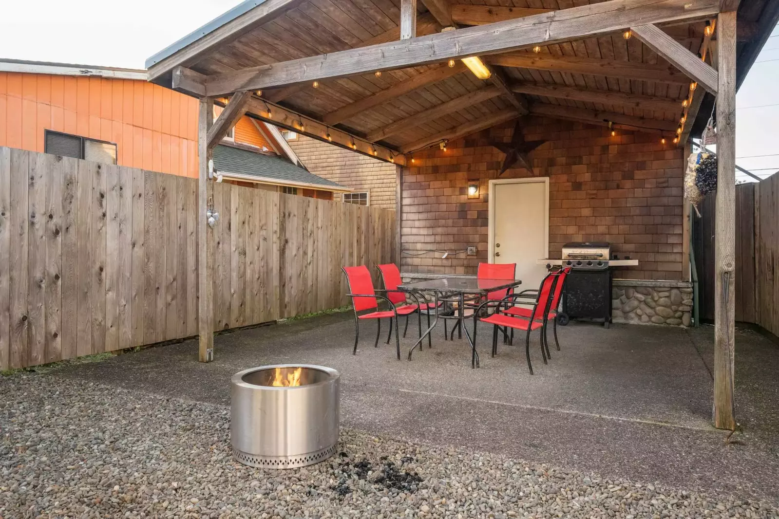 The outside table and chairs are covered so guests can enjoy them in all seasons.