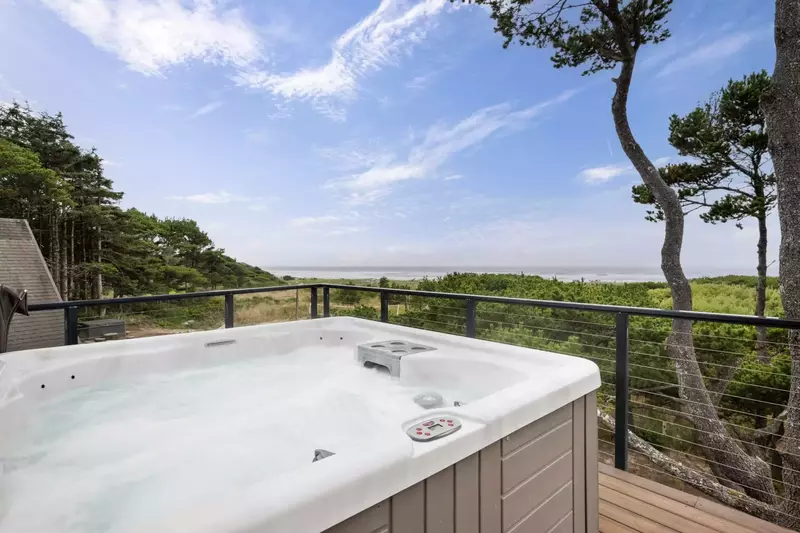 The huge deck just off the main living area enjoys a private six person hot tub and ample seating for your entire group.