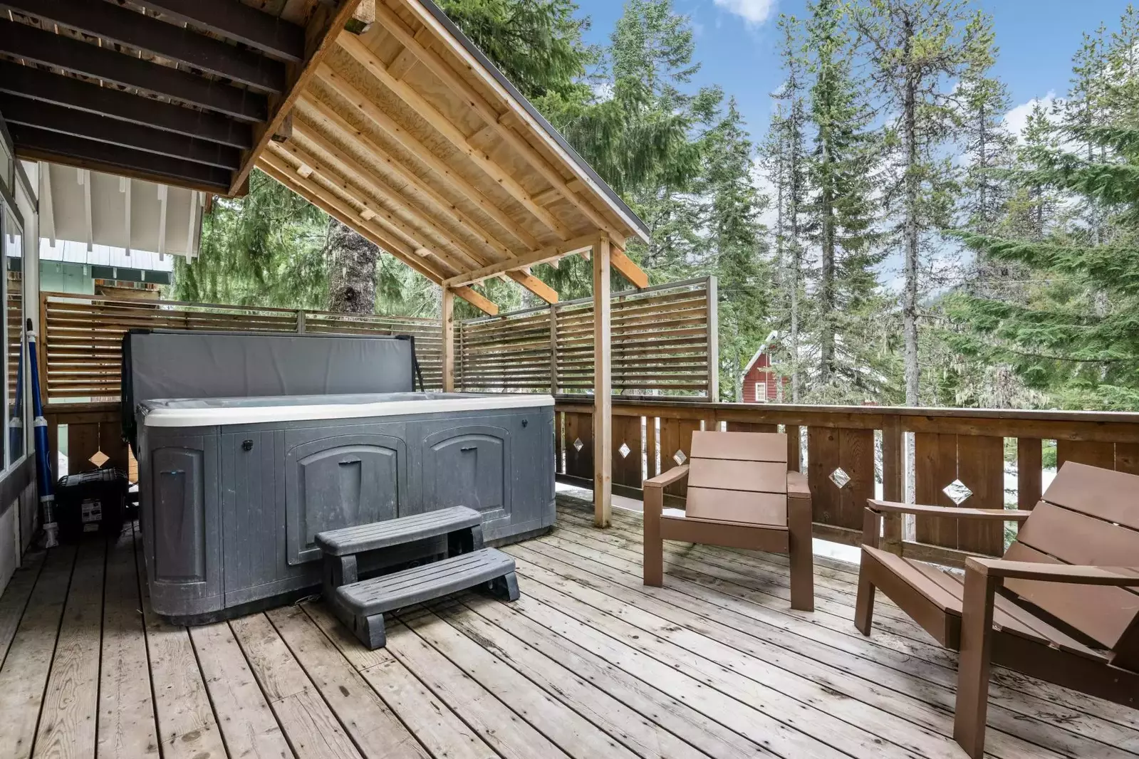 Enjoy relaxing on the deck in the protected hot tub.