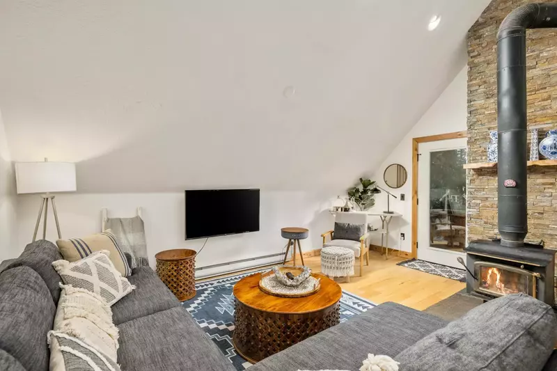 Another comfy room with a smart tv and a fireplace.