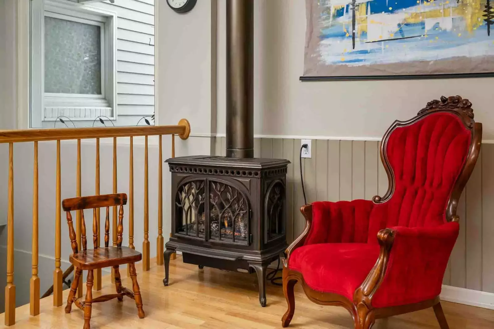 Enjoy sitting in this comfy chair next to a warm decorative stove.