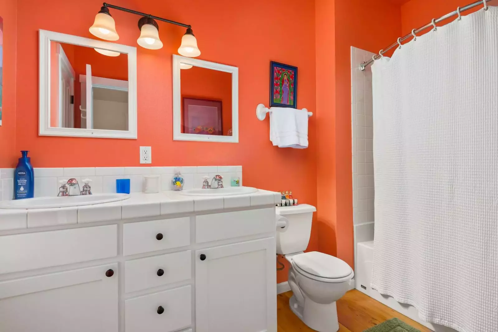This bathroom has two sinks and a shower with excellent water pressure.