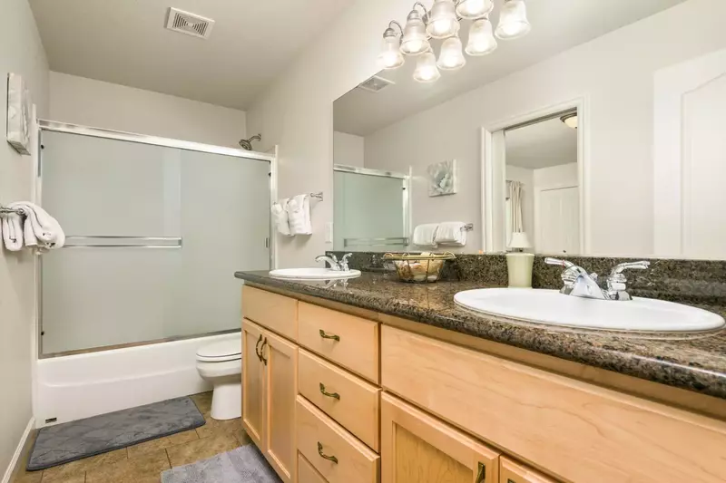 This bathroom has two sinks and a relaxing tub.