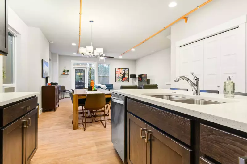 There is lots of space to spread out into with the kitchen and main living area as well as a family/TV room upstairs.  -Karen