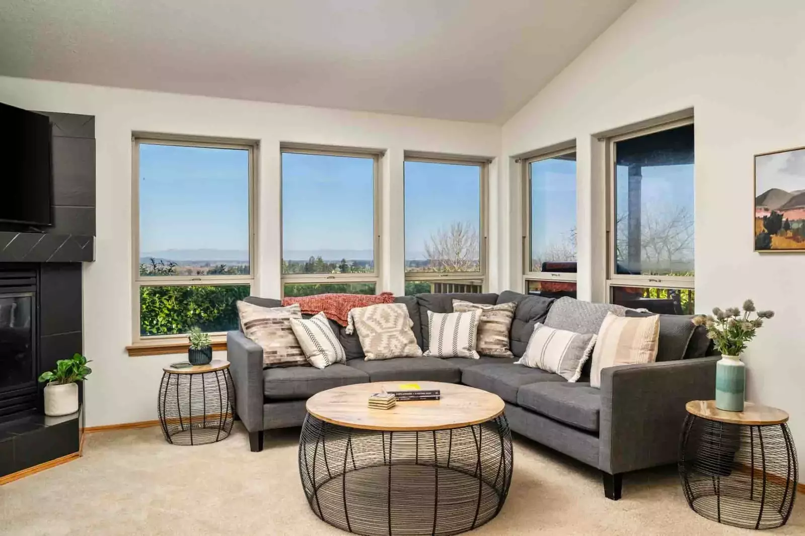 The living room is open and relaxing with a smart tv and fireplace.