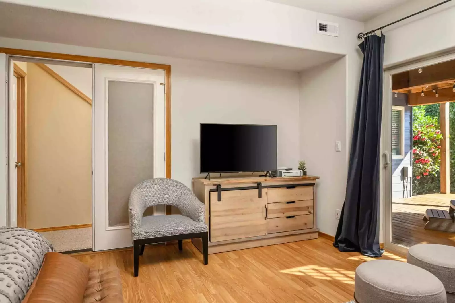 This bedroom has a tv and a lot of space.