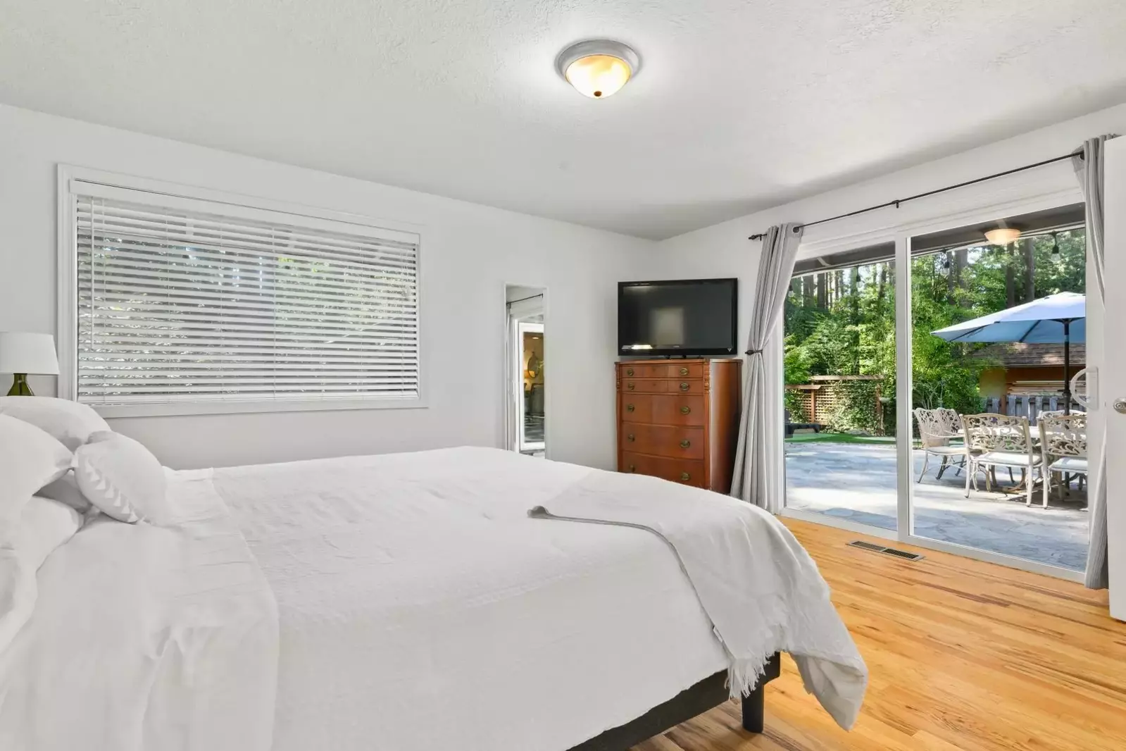 The bedroom has direct access to the deck area.