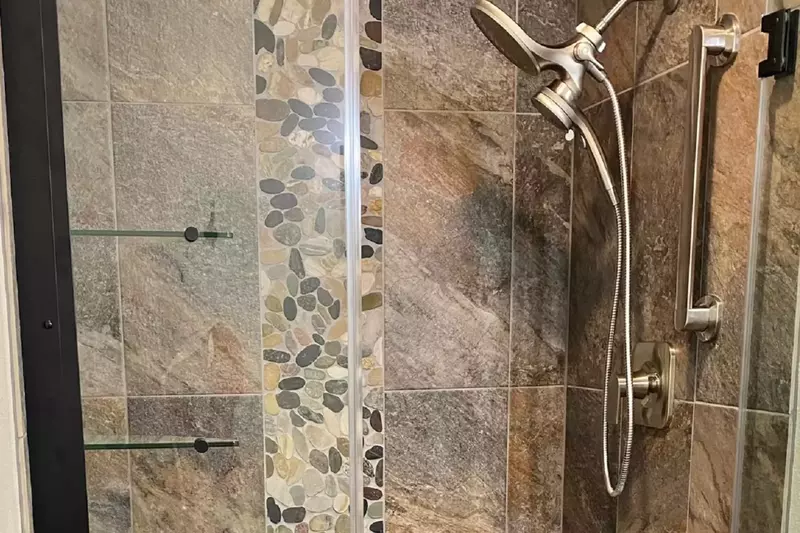 Completely remodeled shower as part of the primary bedroom suite.