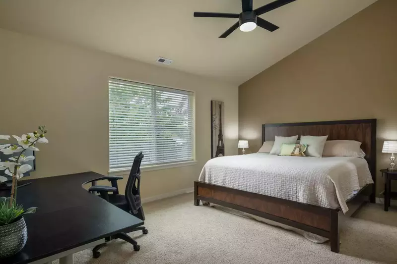 Master bedroom has tons of space and a large desk for work or the always needed surface area.