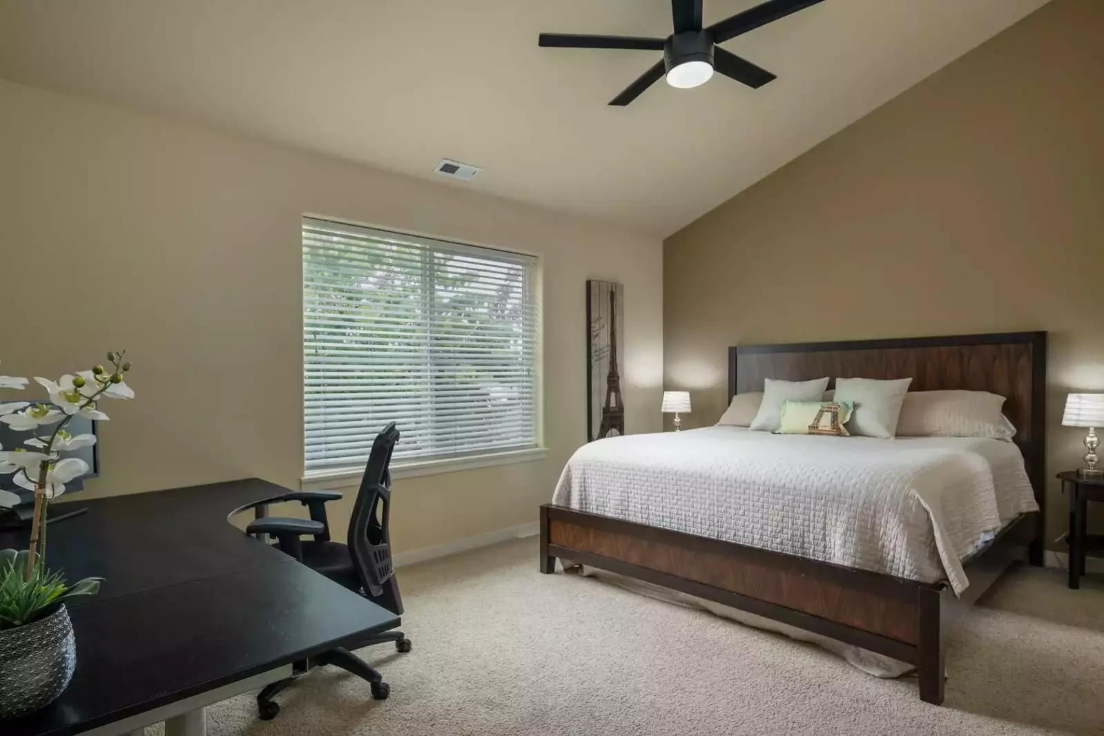 Master bedroom has tons of space and a large desk for work or the always needed surface area.