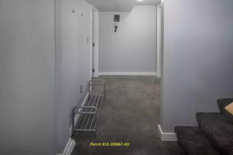 Once down the stair from the side entrance, there is a private hallway leading to the basement retreat