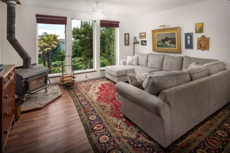 There are incredible views of the forested landscaping, small pond, and the ocean beyond.