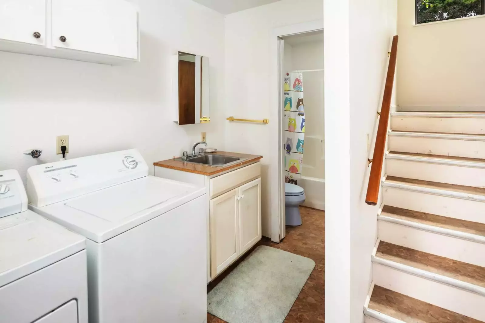 Bottom level laundry room next to full bath.