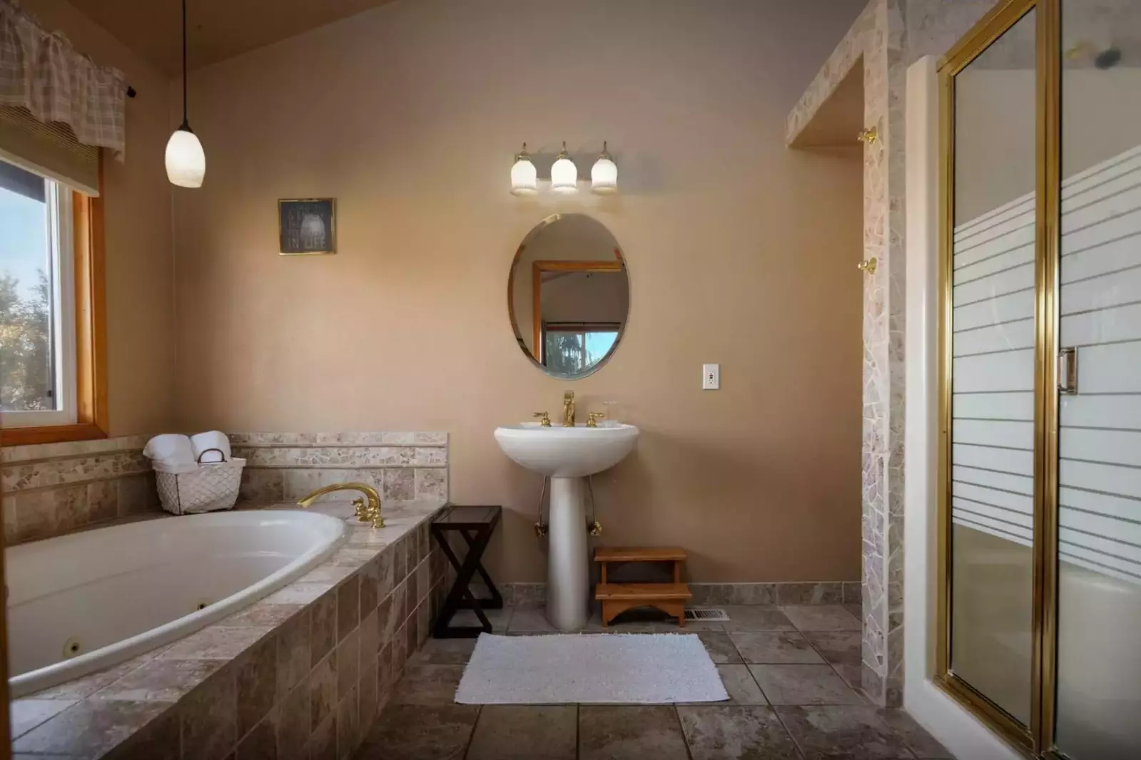 Master bathroom is spacious with a Jacuzzi and dual head shower.