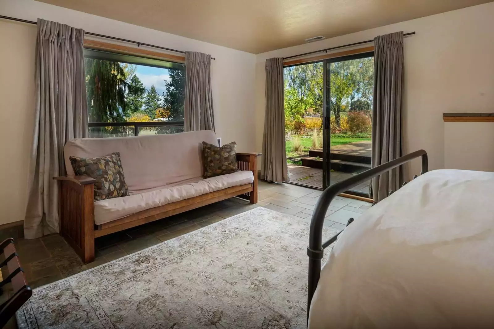 This bedroom has a foldout futon as an option and opens up on to the backyard deck as well.