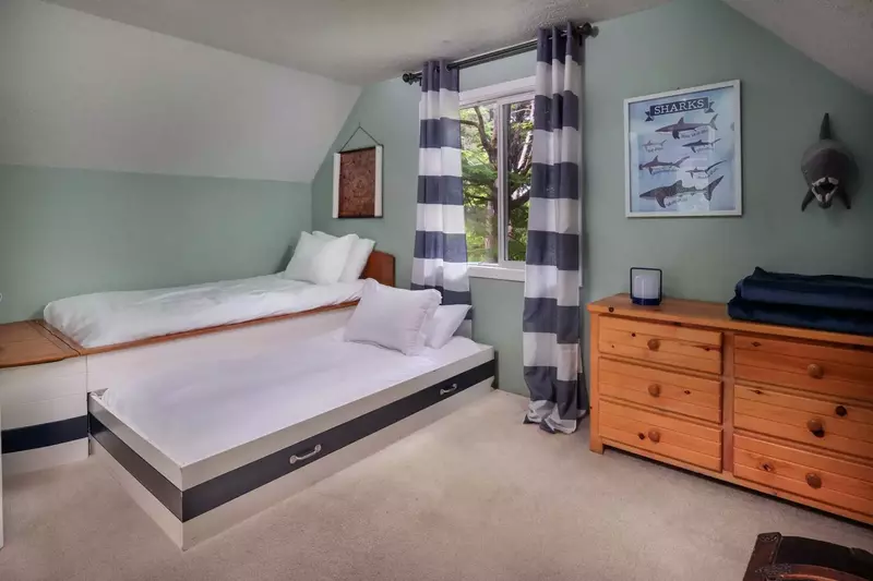 The second twin pulls out with extra bedding in the bow of the main bed