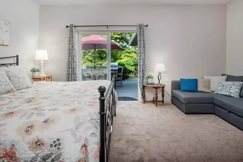 Enjoy the natural light and deck with greenery just off the master bedroom