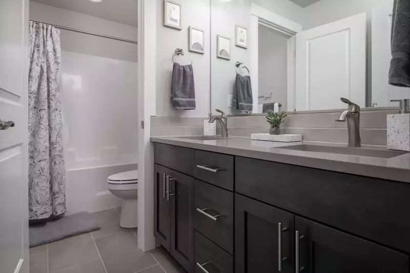 This bathroom has two sinks and a shower with excellent water pressure.