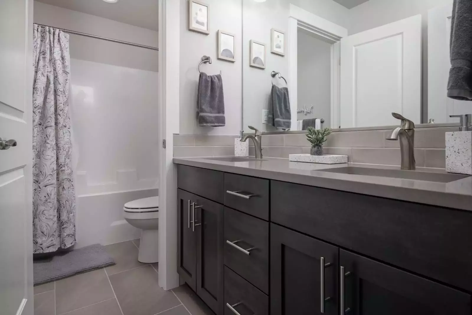 This bathroom has two sinks and a shower with excellent water pressure.
