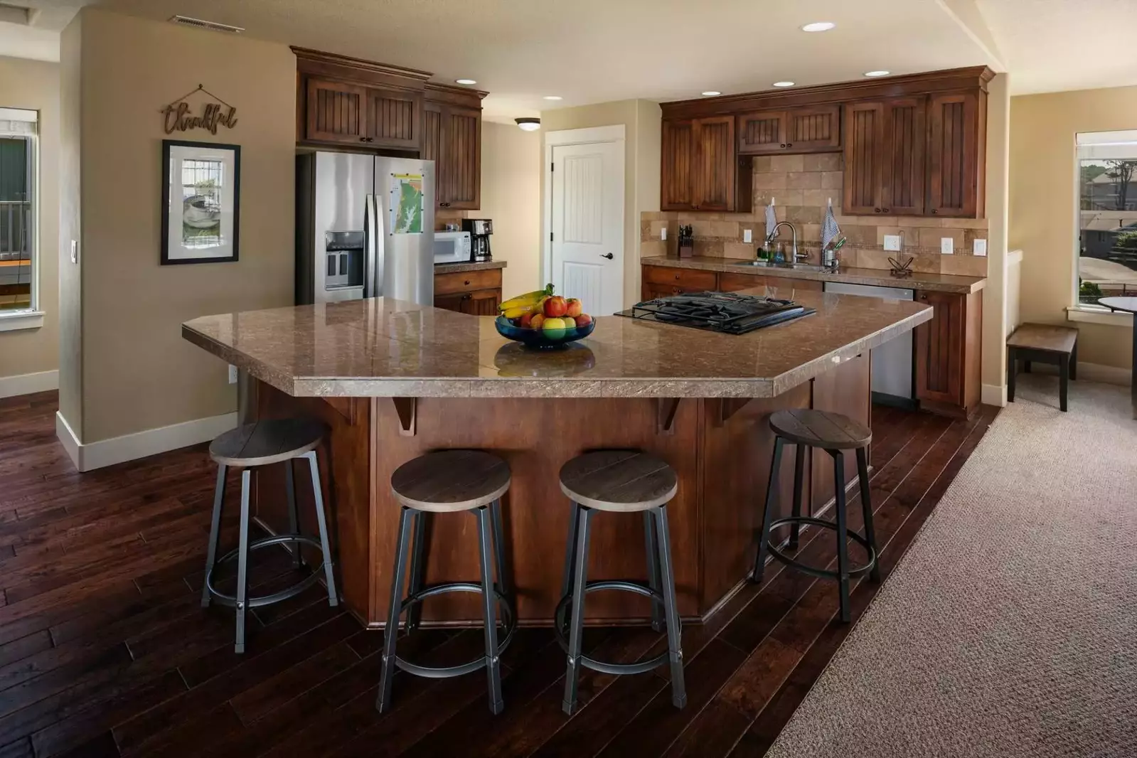 Open kitchen and dining area with additional bar seating.