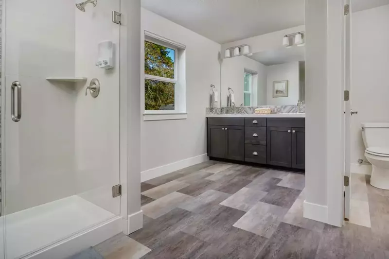 Huge primary bathroom filled with upgrades and dual sinks.