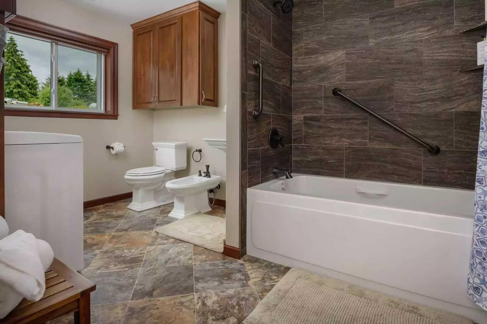 This spacious bathroom offers a large soaking tub and a bidet.