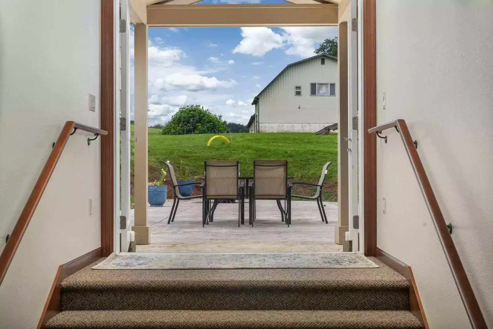 This wide hallway and double doors lead out onto the huge patio.