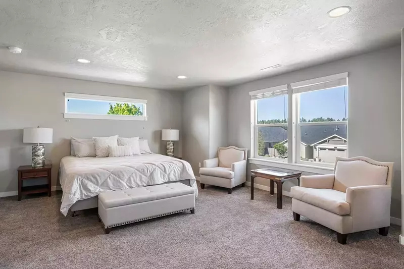 The primary bedroom has a king bed, lots of space, and an en suite bathroom.