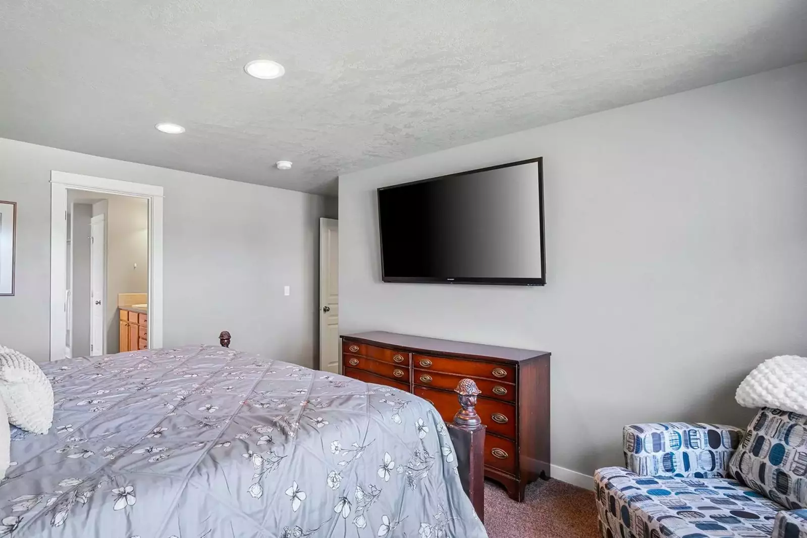 Another bedroom with a smart tv and a comfy bed.