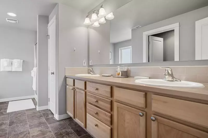A spacious bathroom with two sinks.