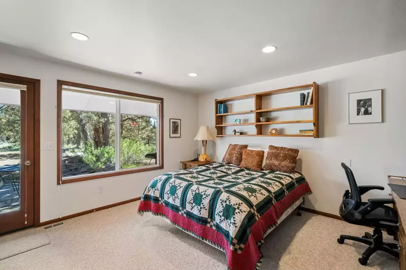 This bedroom has a home office set up and immediate access to nature.