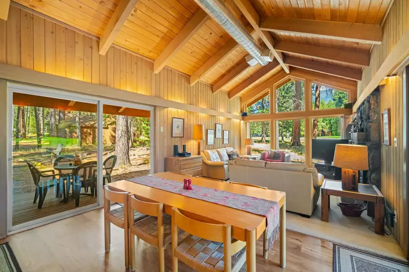 Enjoy vaulted ceilings, exposed beams, and a wall of windows in the main living area, creating a bright and inviting space.
