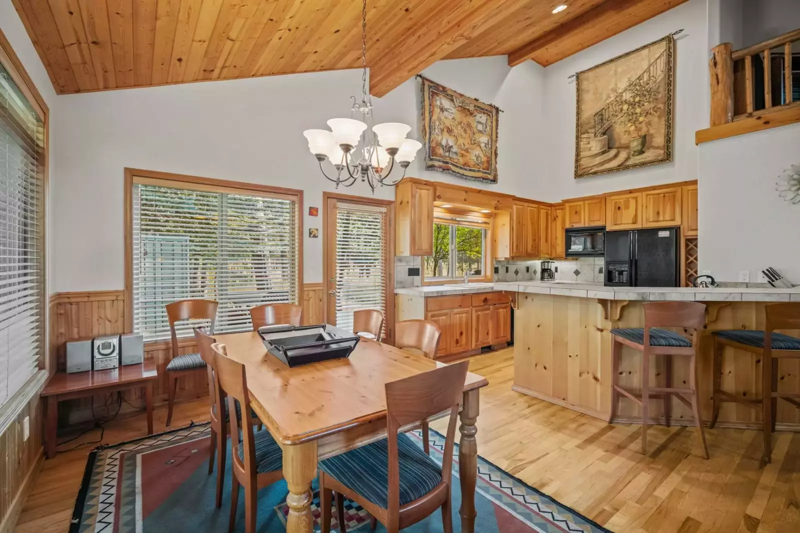Plenty of seating at the breakfast bar and window-lined dining table—perfect for shared meals and good conversations.