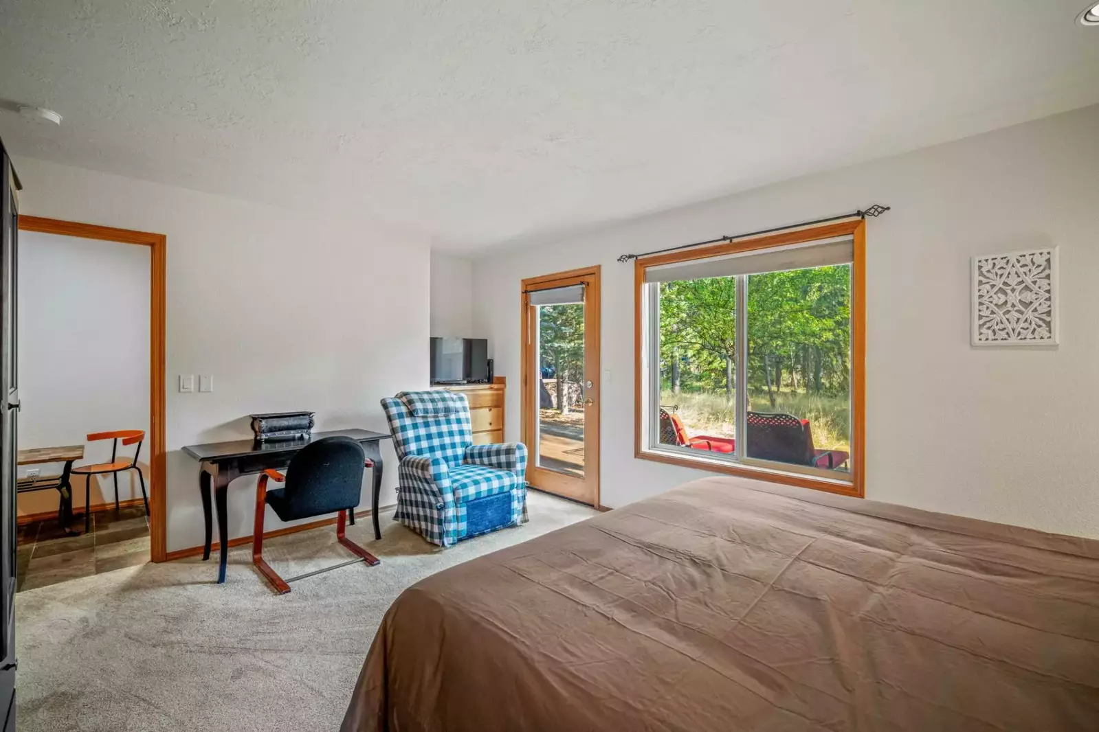 Primary suite on the main floor features direct access to the outdoors and a private bathroom.