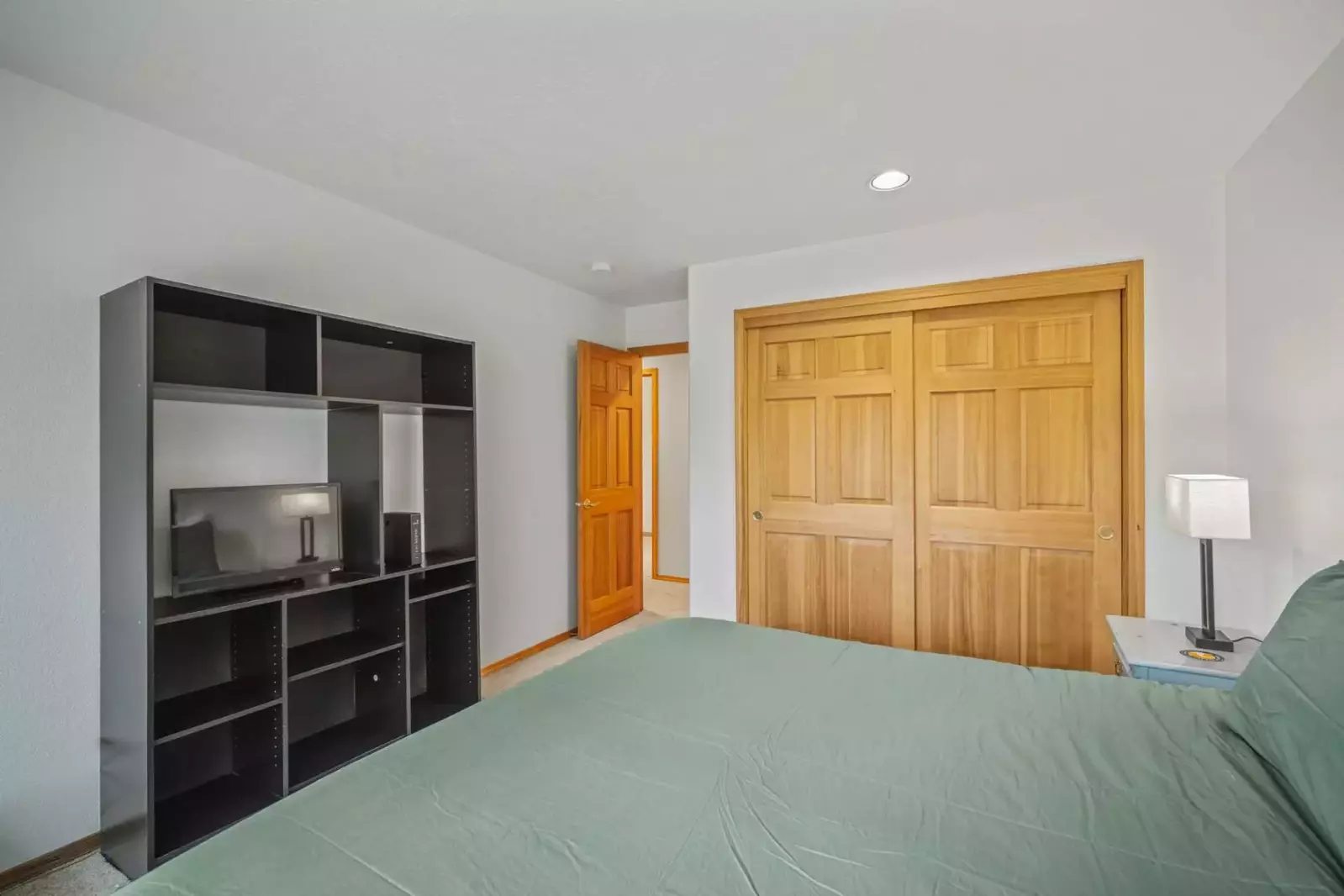 Queen bedroom offers storage space and TV.