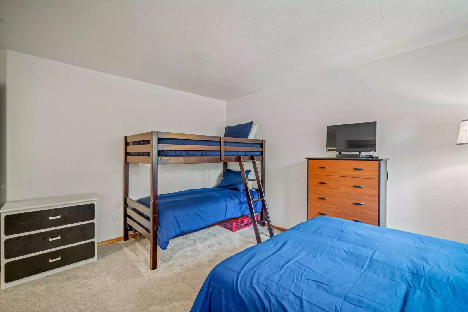 Twin bunk beds along with a queen bed.