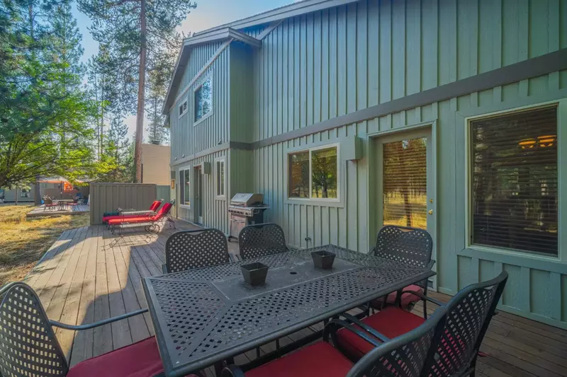 The expansive deck overlooks serene woods.