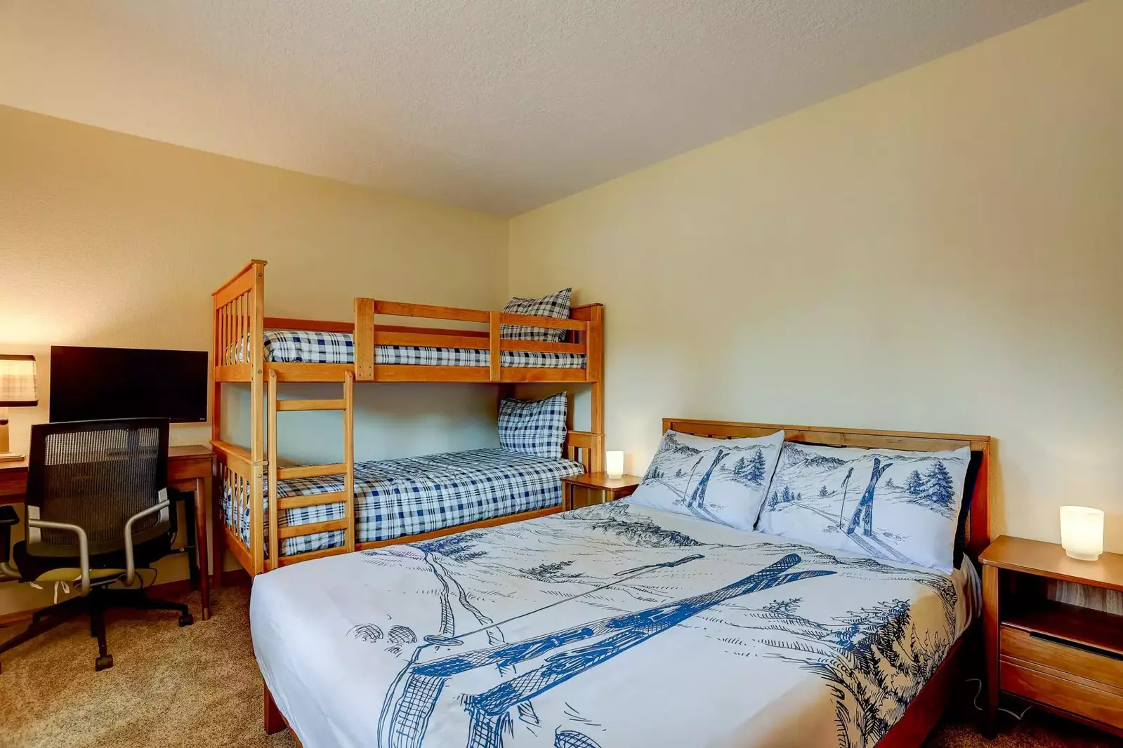 Third bedroom features a Queen and Twin bunks.  Functional workspace and professional chair.