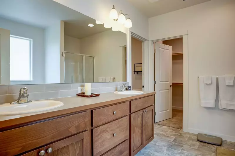 Master bath with dual sinks, walk-in shower and tub