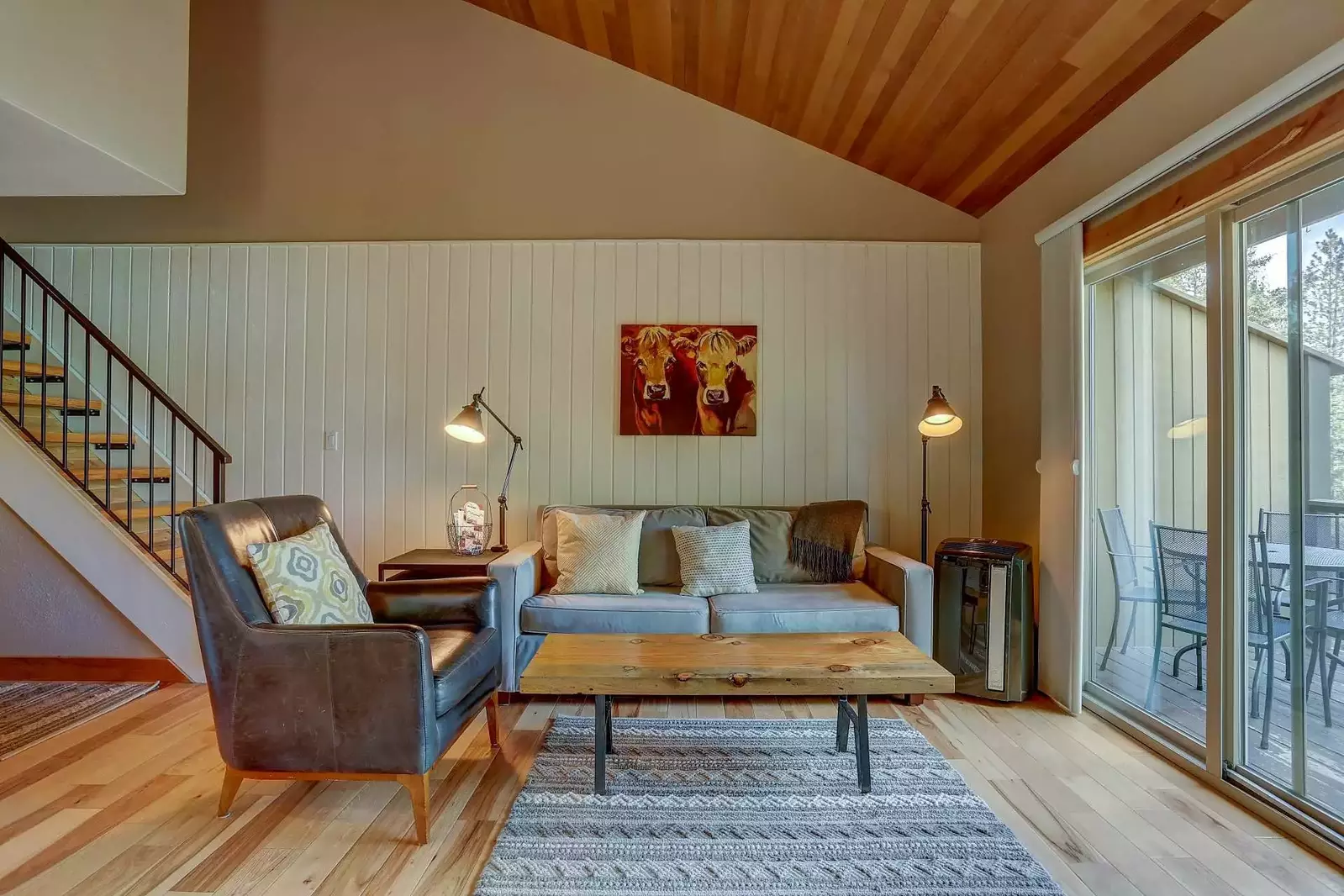 Open living space accentuated with vaulted wood-paneled ceiling.