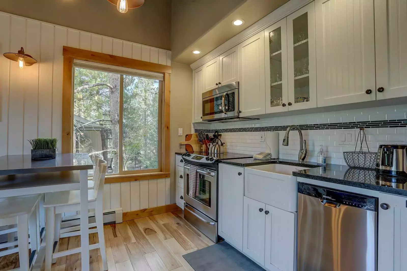 Stainless steel luster in fully equipped galley kitchen.