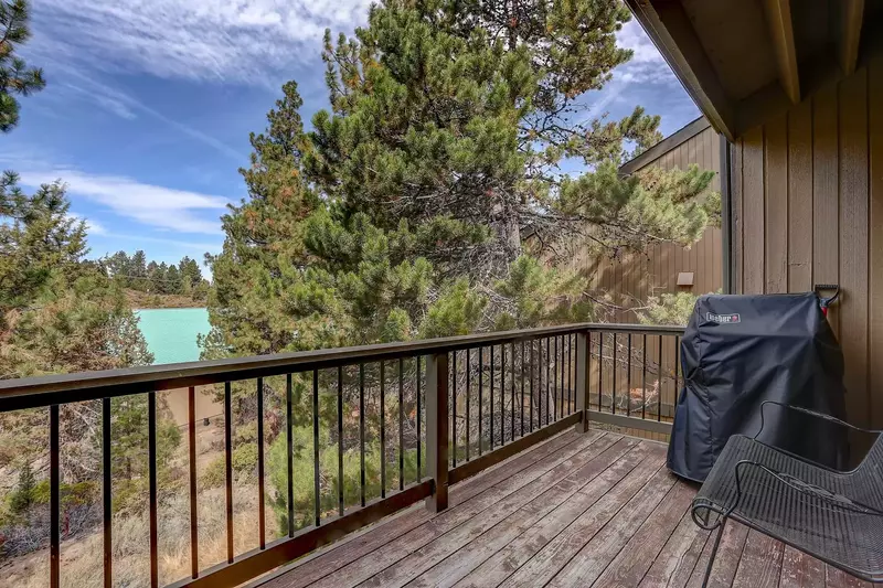 Deck off backside furnished with Weber gas grill and wrought iron furniture