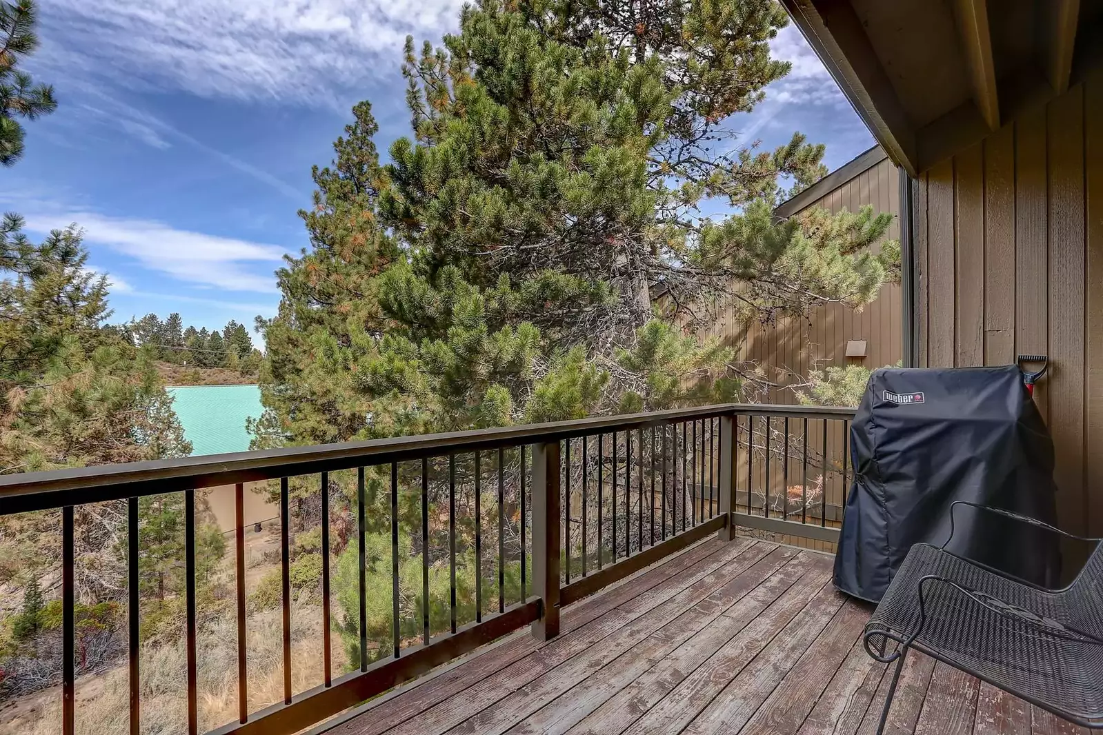 Deck off backside furnished with Weber gas grill and wrought iron furniture