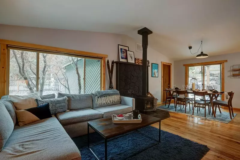 Rustic feel with hardwood floors, valuted ceiling and wood-burning stove