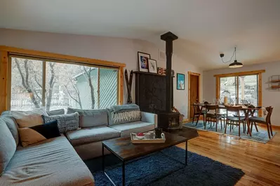 Rustic feel with hardwood floors, valuted ceiling and wood-burning stove