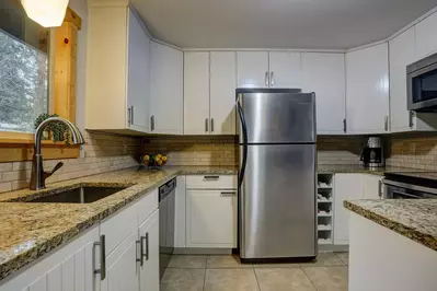 Granite countertops and a full array of appliances in the kitchen.