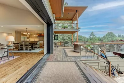 A 15 foot pocket sliding wall opens up for indoor/outdoor living with incredible river views.