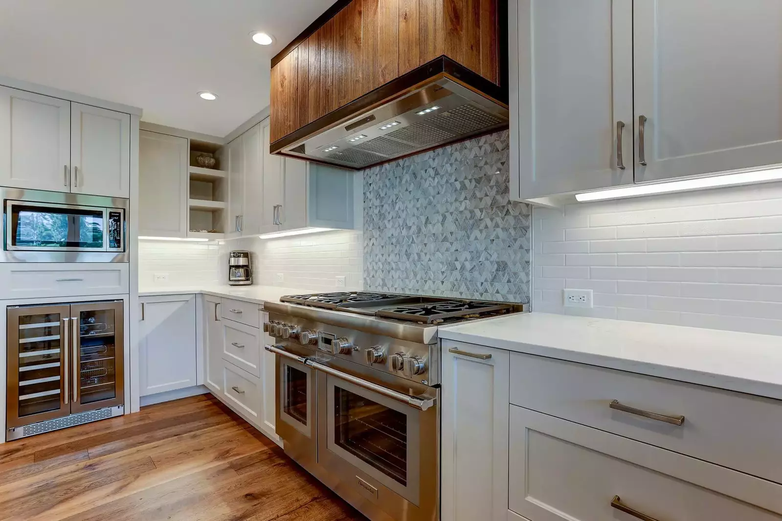 Thermador appliances include a 48 inch gas range with griddle and double oven, wine fridge and commercial grade refrigerator/freezer with ice maker